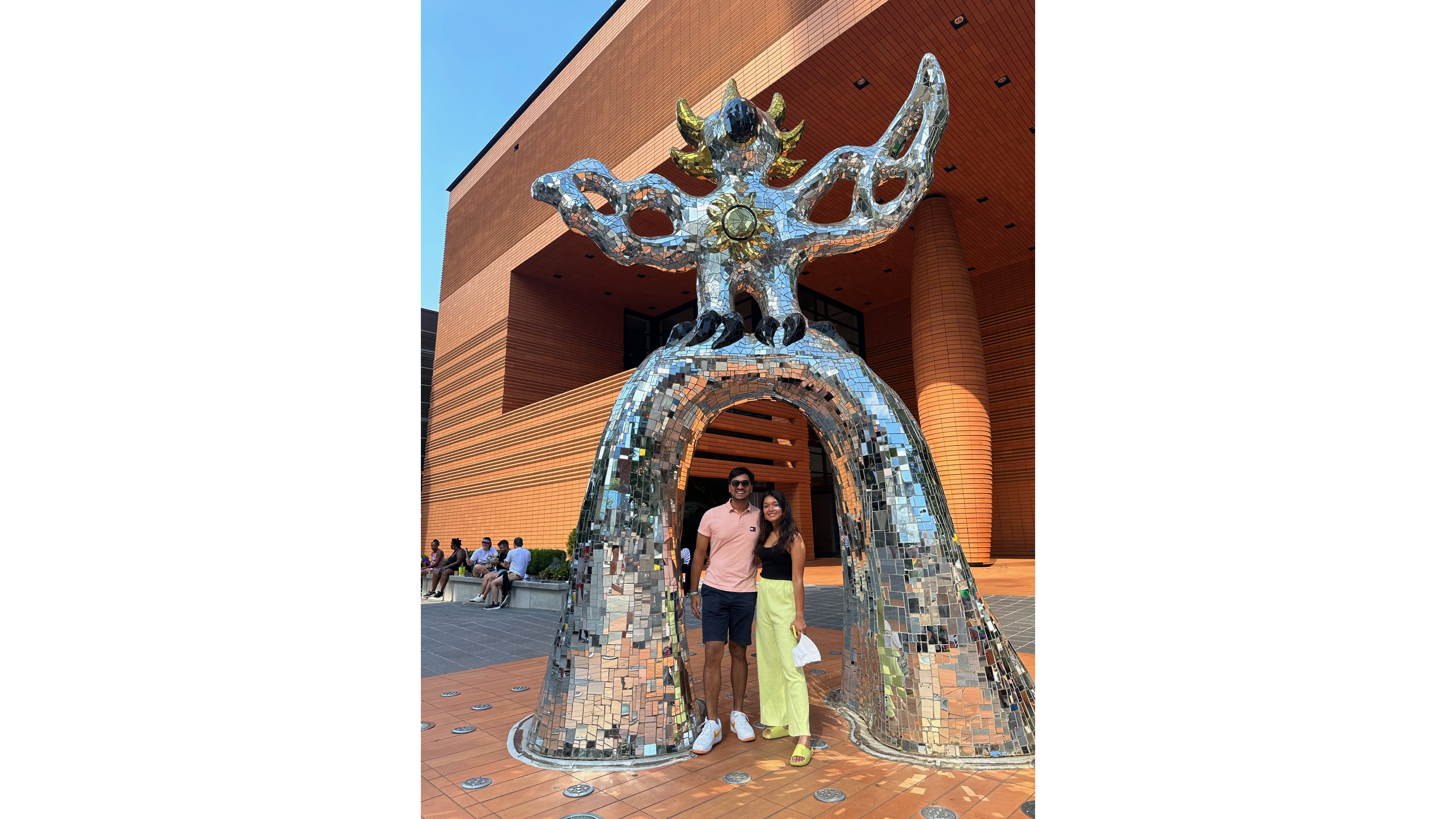 Atul and Unnati beneath a sculpture on one of their visits