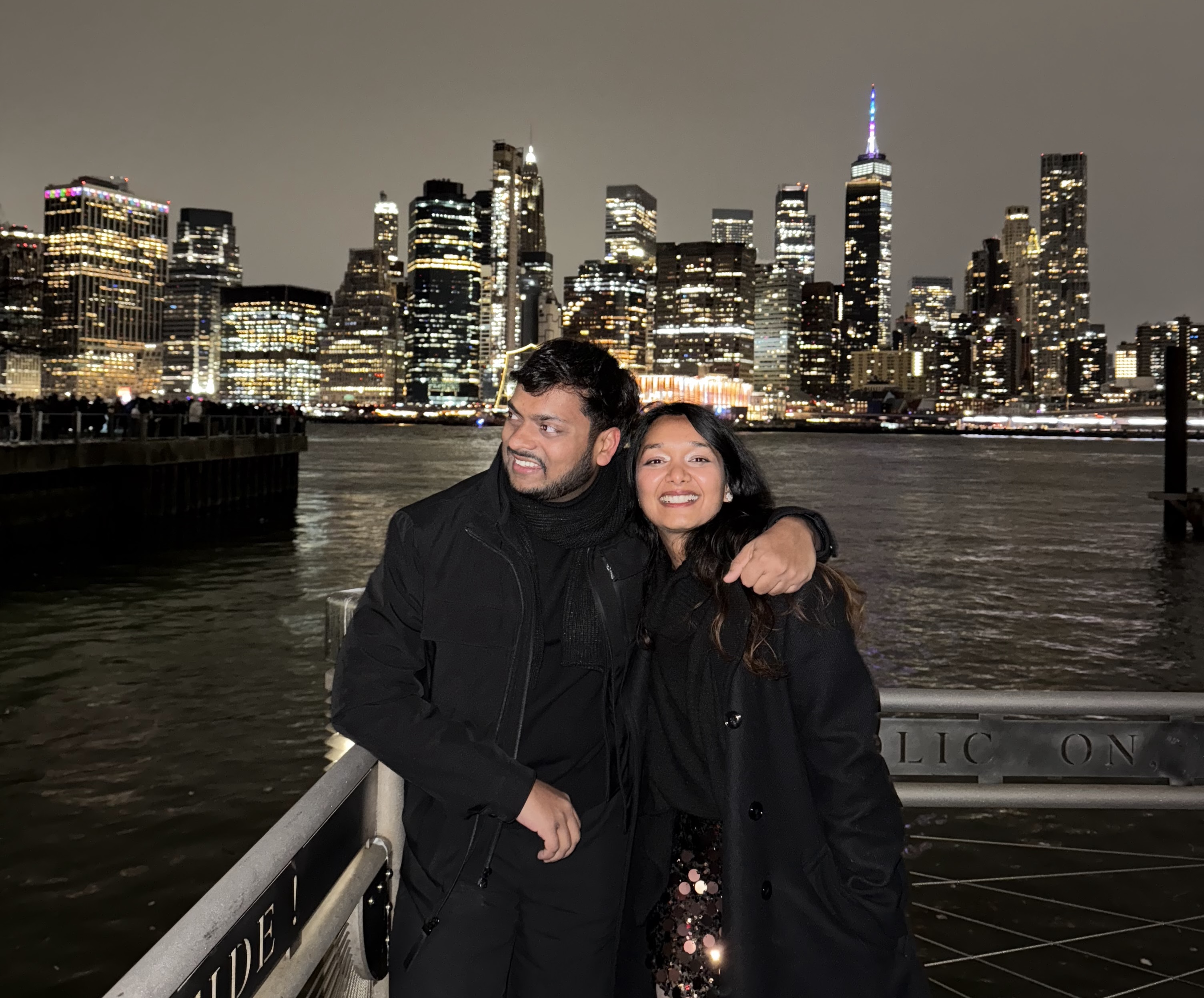 Atul and Unnati together against the New York City skyline at night